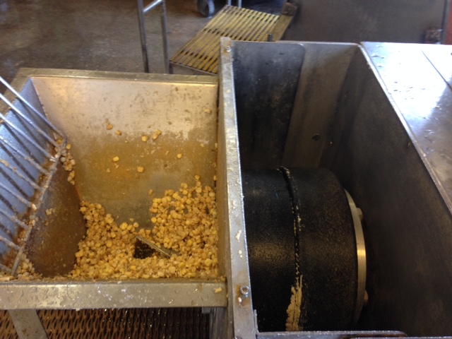 Photo of volcanic rock corn grinder at Adelita Tamales & Tortilla Factory.