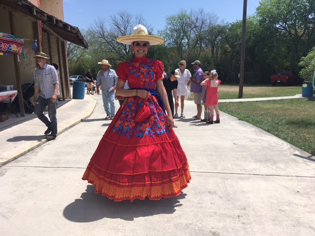 Female horseback rider in stunning red dress.