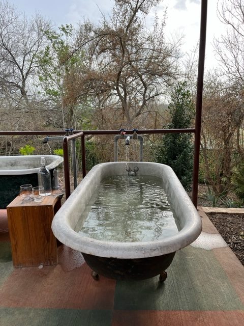 Photograph of clawfoot tub filled with medicinal hot springs at Camp Hot Wells in San Antonio, Texas.