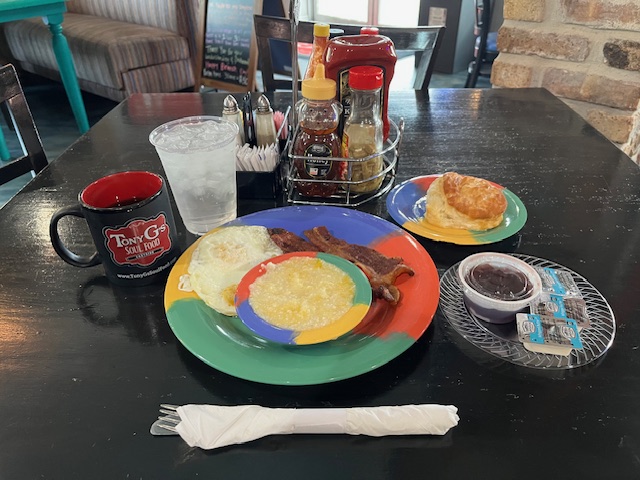 Photo of the senior breakfast special at Tony G's: coffee, two eggs, grits, bacon and a biscuit.